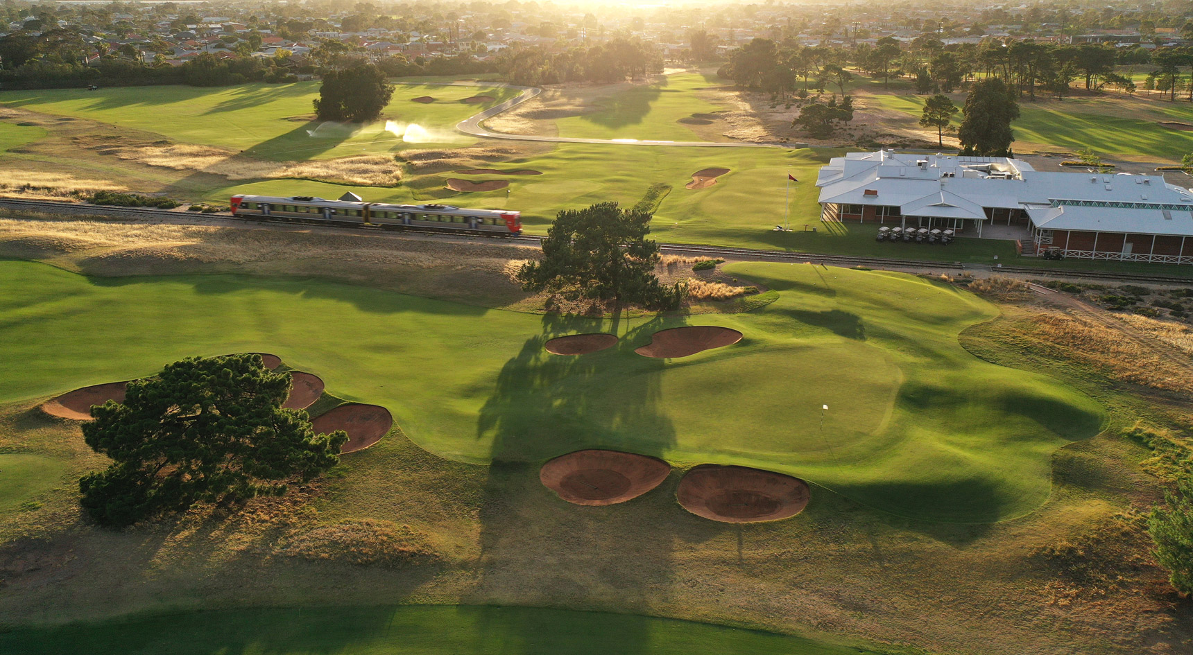 Train on the Grange Line through a golf course