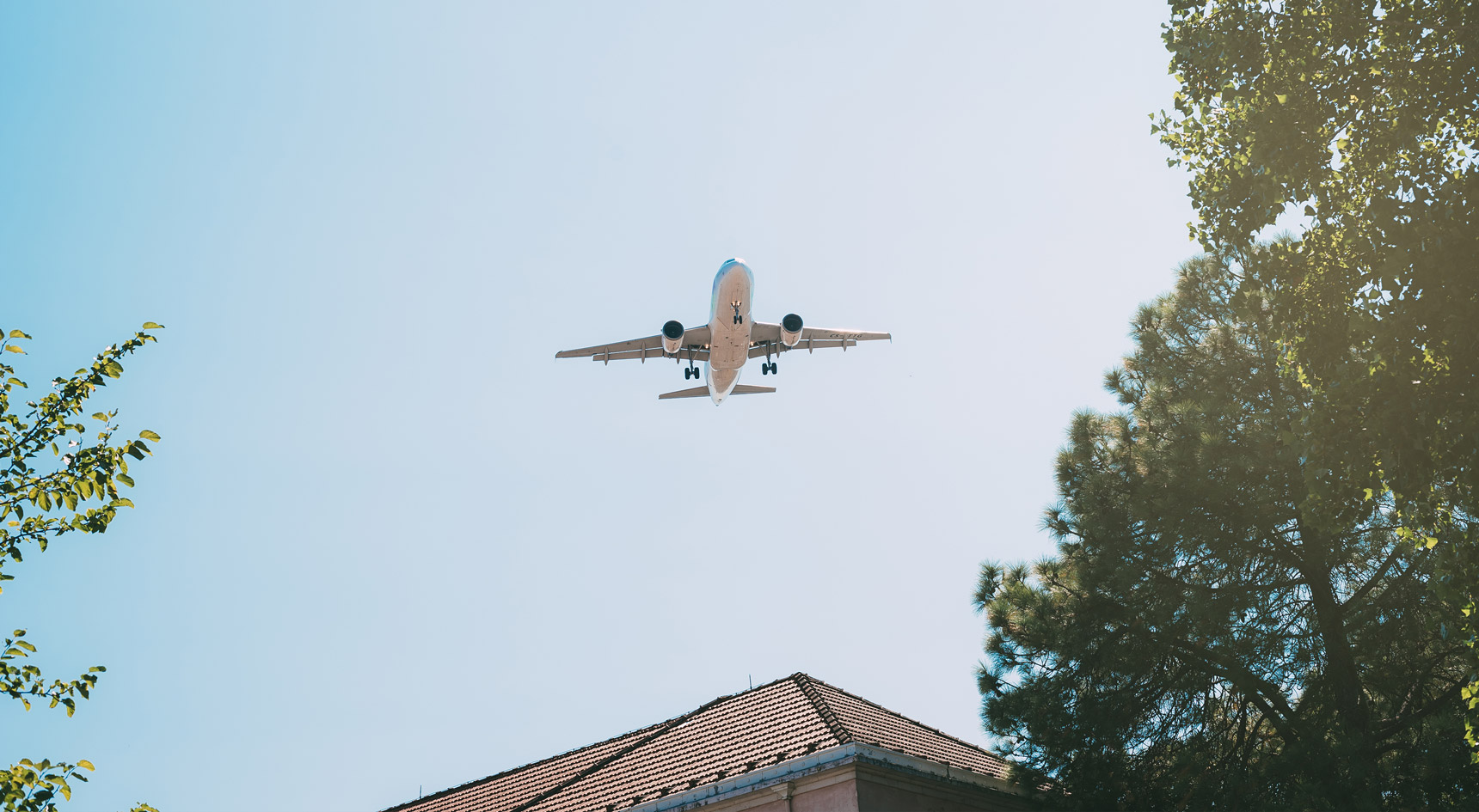 Plane flying over house