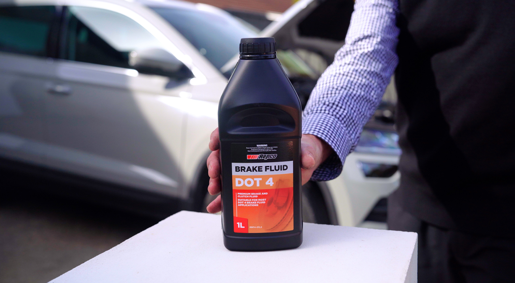 Closeup of a bottle of genuine brake fluid