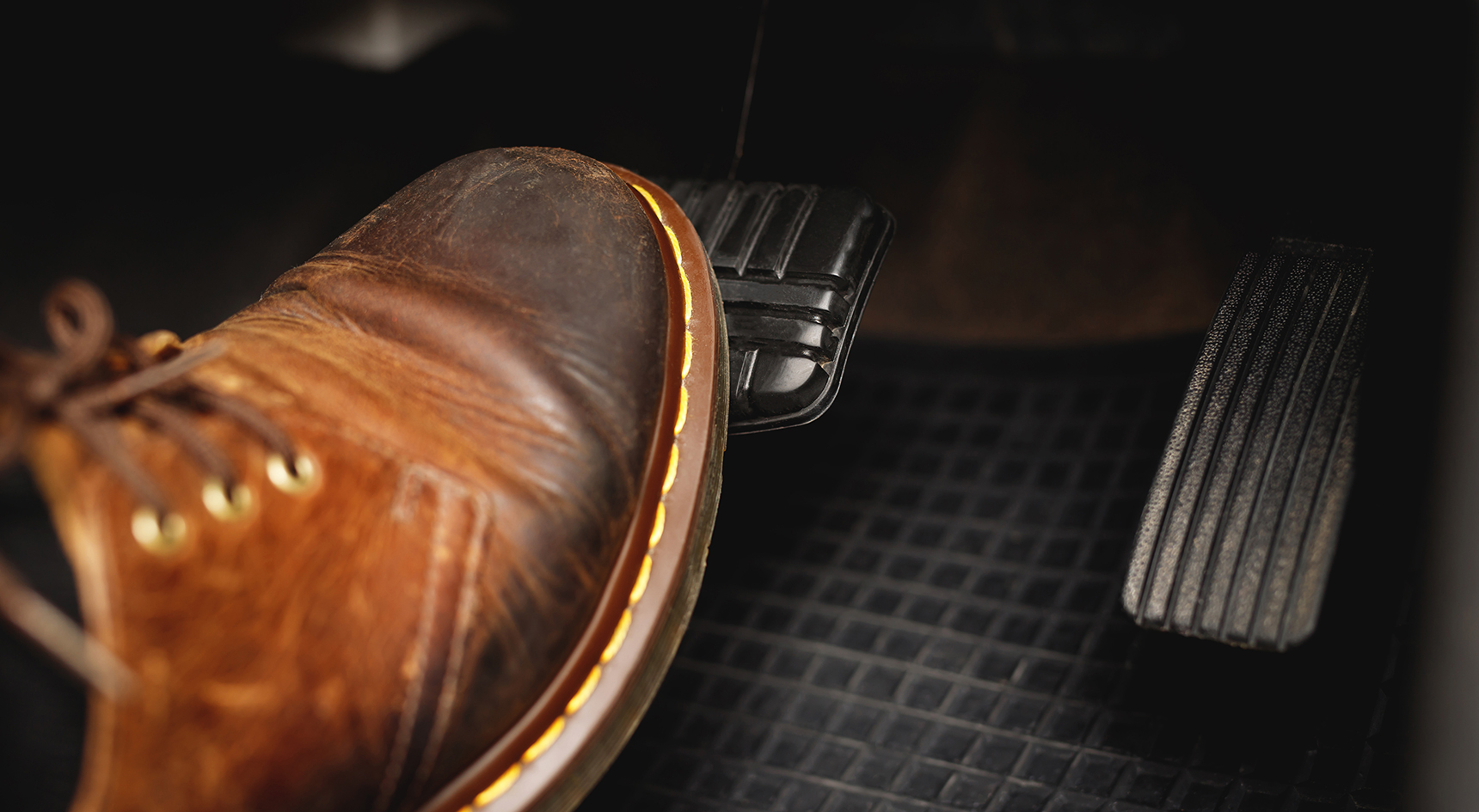 Close up of a man stepping on a brake to slow down