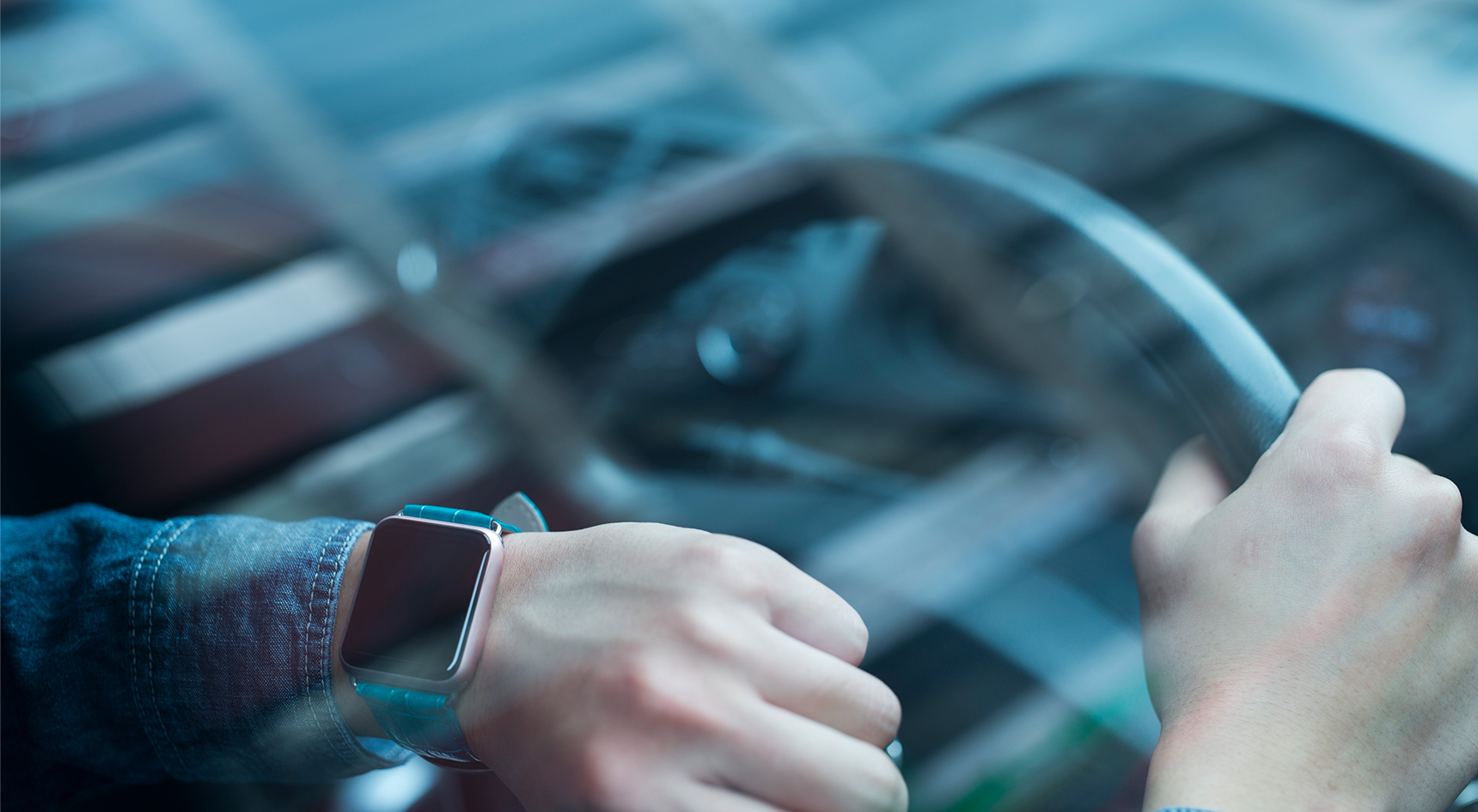 Driver looking smartwatch while behind the wheel