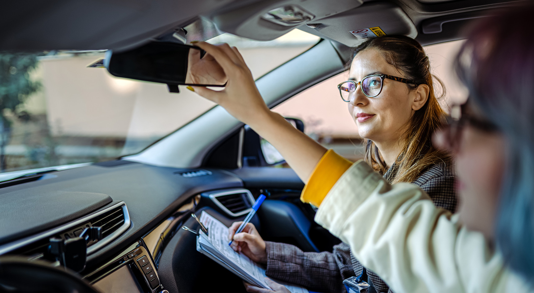 Woman having driving lesson with female instructor