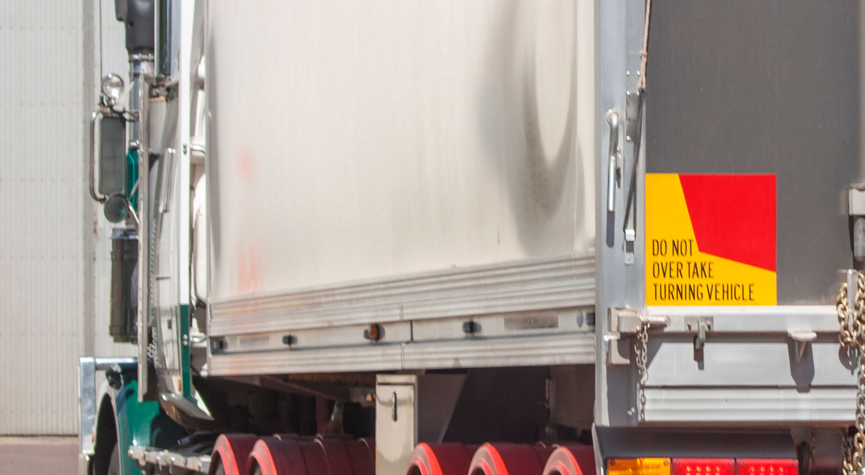 A do not overtake when turning sign on the back of a truck