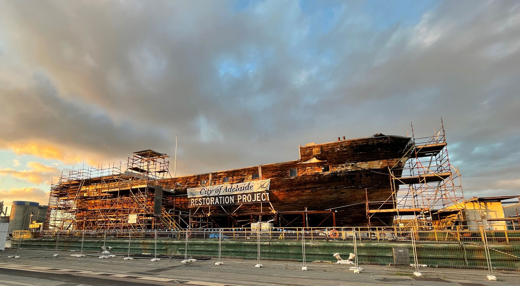 Ship under construction with dramatic clouds