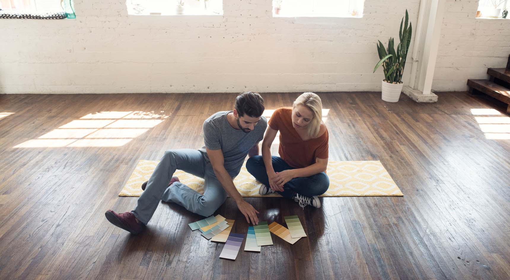 A male and female looking at paint colours.