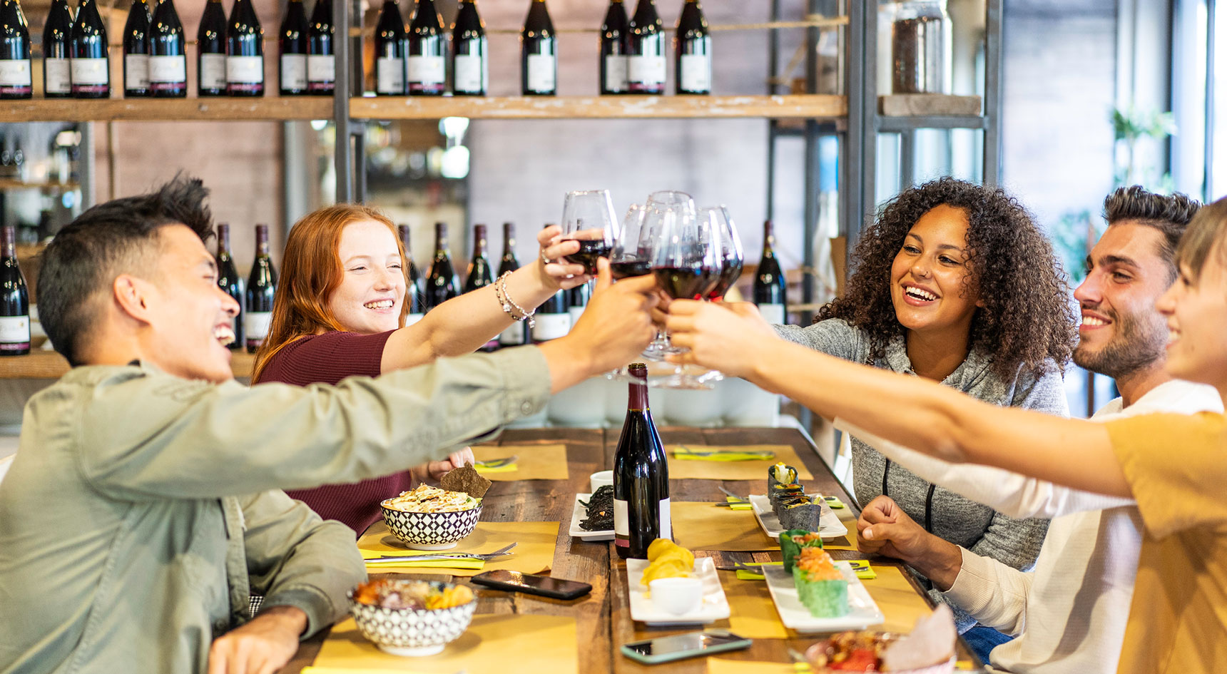 Friends saying cheers with glasses of wine