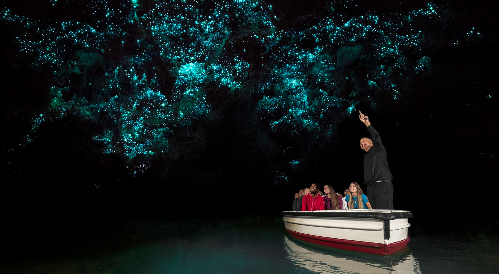 Small boat under a glowworm canopy