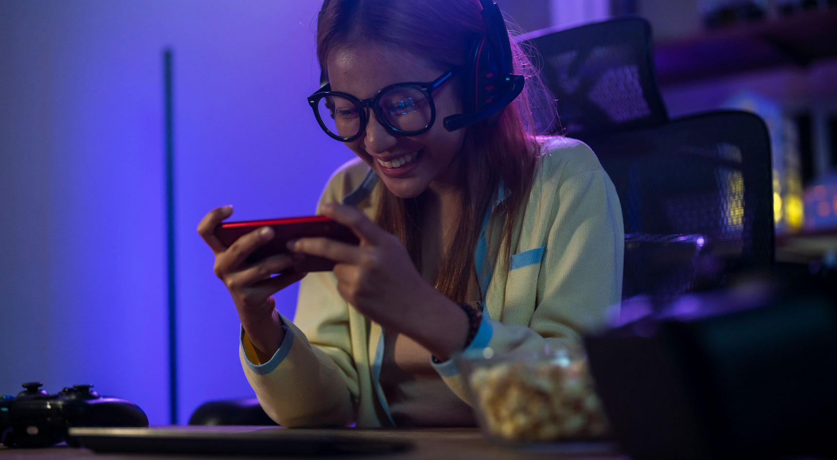 Woman looking at her phone while wearing headphones