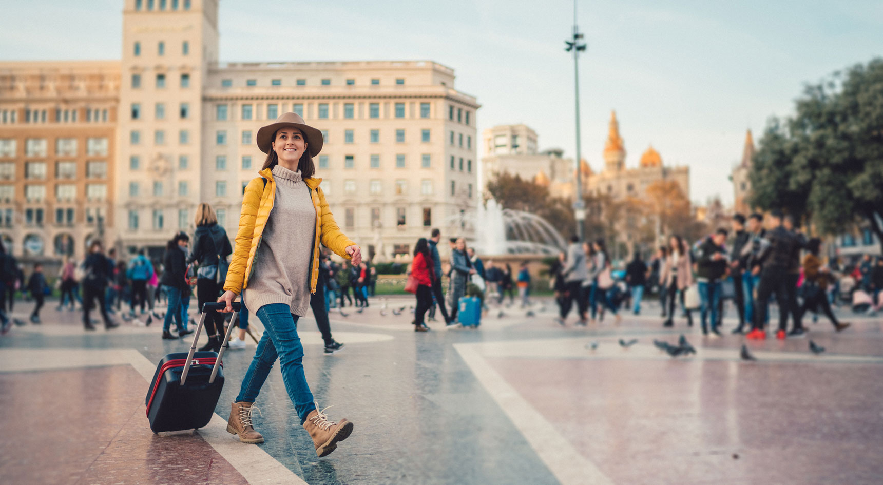 Woman wheeling a suitcase in Europe