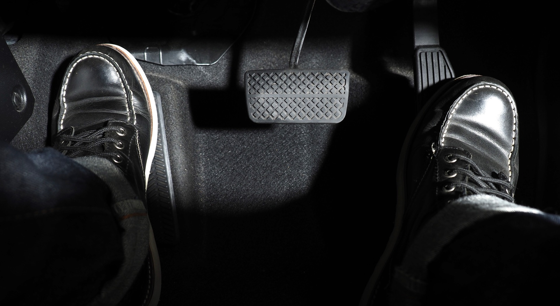 One foot on accelerator, one on footrest